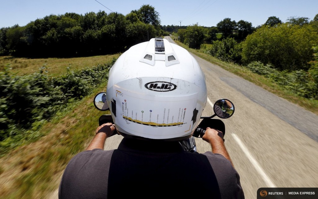 The stage map is seen on the back of the helmet of the Reuters motorbike driver as he rides during the 7th stage of the 102nd Tour de France cycling race from Livarot to Fougeres, France, July 10, 2015. Photographing the Tour de France cycling race comes with highs and lows: the buzz from capturing just the right image, the tedium of long journeys, the painstaking set-up of equipment, the breath-taking scenery. Reuters photographers have worked not only to capture the thrills and spills on the roads and mountain passes. They have also shot a set of pictures showing their own quirky view from behind the scenes as they travelled through the Netherlands, Belgium and France. REUTERS/Stefano Rellandini TPX IMAGES OF THE DAY      PICTURE 2 OF 36 FOR WIDER IMAGE STORY "ON THE SIDELINES - THE TOUR DE FRANCE"  SEARCH "SIDELINES TOUR" FOR ALL PICTURES