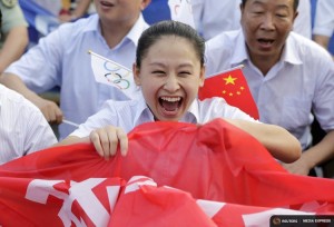 Local resident Zhang Jing celebrates after Beijing was chosen to host the 2022 Winter Olympics at a square in Chongli county of Zhangjiakou, jointly bidding to host the 2022 Winter Olympic Games with capital Beijing, July 31, 2015. REUTERS/Jason Lee