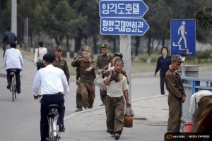 "Soldier-builders" carry things in central Pyongyang October 8, 2015. Picture taken October 8, 2015. To match Insight NORTHKOREA-CHANGE/ REUTERS/Damir Sagolj