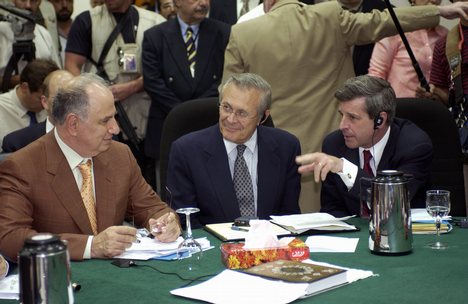 Ahmed Chalabi in discussion with Paul Bremer and Donald Rumsfeld. Photo by MSgt. James Bowman 