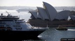 The Sydney ferry Golden Grove (R) moves between the Sydney Opera House and new P&O Cruises ship Pacific Aria in Sydney, Australia, November 25, 2015. Sydney's ferry system has been its lifeblood since the mid 1800s, transporting more than 15 million individual passenger journeys each year, according to the Bureau of Transport Statistics. From fast-food employees to finance industry executives, more than 40,000 trips are taken every day. Picture taken November 25, 2015. REUTERS/Jason Reed