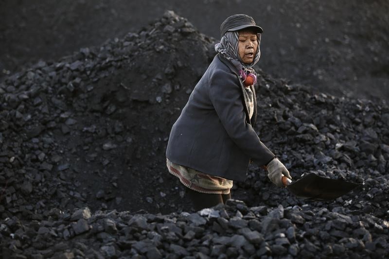 A villager moves coal at local businessman Sun Meng's small coal depot near a coal mine of the state-owned Longmay Group on the outskirts of Jixi, in Heilongjiang province, China, October 23, 2015. To match story CHINA-COAL/JIXI Picture taken on October 23, 2015. REUTERS/Jason Lee