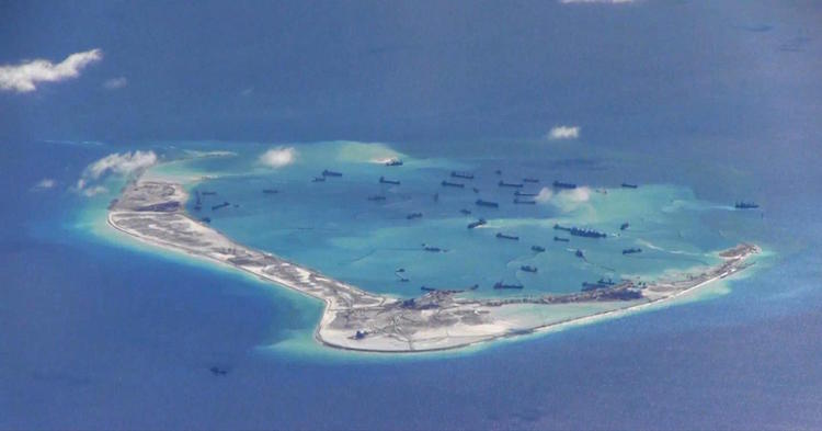 Chinese dredging vessels in the waters around Mischief Reef in the disputed Spratly Islands in the South China Sea. U.S. Navy photo, Public Domain