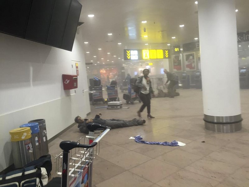 An injured man lies at the scene of explosions at Zaventem airport near Brussels, Belgium, March 22, 2016. REUTERS/Ketevan Kardava/Courtesy of 1tv.ge/Handout via Reuters