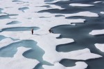 The crew of the U.S. Coast Guard Cutter Healy, in the midst of their ICESCAPE mission, retrieves supplies in the Arctic Ocean in this July 12, 2011 NASA handout photo. Kathryn Hansen/NASA via REUTERS/File Photo