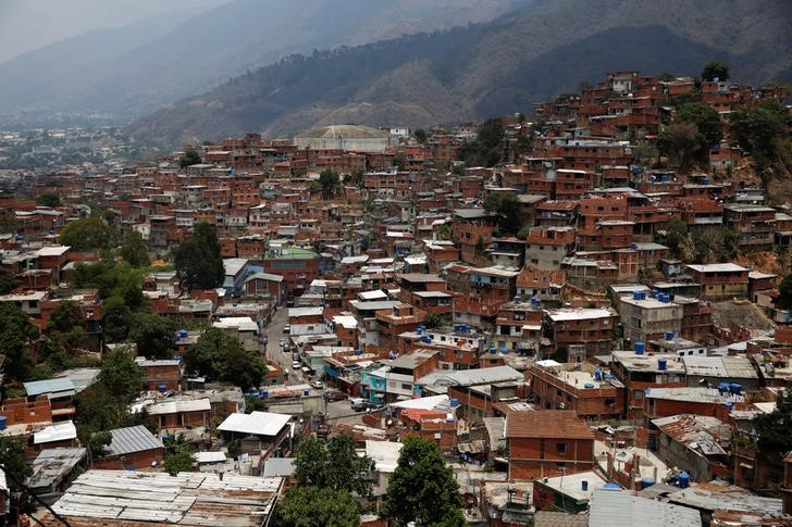 A non-operative water tank is seen in a neighbourhood called "The Tank" in the slum of Petare in Caracas, Venezuela, April 3, 2016. Although their nation has one of the world's biggest hydroelectric dams and vast rivers like the fabled Orinoco, Venezuelans are still suffering water and power cuts most days. The problems with stuttering services have escalated in the last few weeks: yet another headache for the OPEC nation's 30 million people already reeling from recession, the world's highest inflation rate, and scarcities of basic goods. President Nicolas Maduro blames a drought, while the opposition blames government incompetence. REUTERS/Carlos Garcia Rawlins 