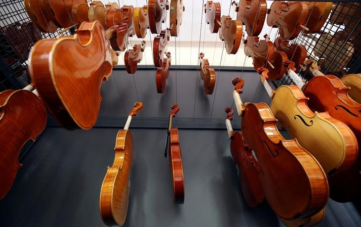Violins made by students hang to dry at a laboratory of the Antonio Stradivari institute of higher education in Cremona, Italy, April 22, 2016. Making violins is a passion in Cremona, the ancient Italian town that has been producing them since the 16th century, but turning passion into profits has not been easy. Cremona, in northern Italy, has more than 100 workshops making violins and other stringed instruments for musicians worldwide, following in the tradition of its great violin-makers which have included Antonio Stradivari and Nicolo Amati. REUTERS/Stefano Rellandini
