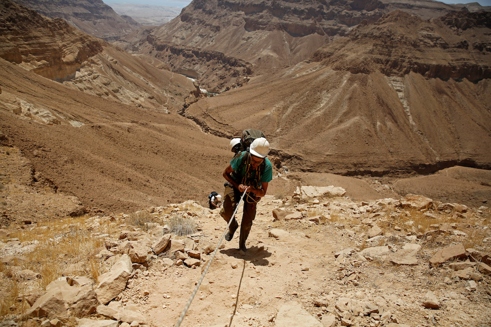 Feature: A search is underway for the Dead Sea Scrolls. A volunteer of the Israeli Antique Authority holds a securing rope as he climbs out of the Cave of the Skulls, an excavation site in the Judean Desert near the Dead Sea, Israel June 1, 2016. REUTERS/Ronen Zvulun 