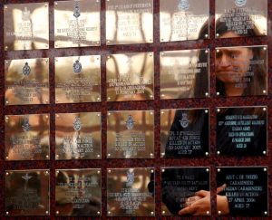 A woman weeps as she looks at the Basra memorial wall before its rededication at the National Arboretum in Alrewas, central England, March 2010. REUTERS/Darren Staples