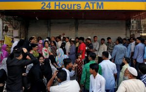 People queue outside a bank to withdraw cash and deposit their old high denomination banknotes in Mumbai, India, December 2, 2016. REUTERS/Danish Siddiqui/File Photo